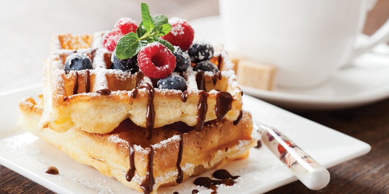 Waffles with berries and chocolate drizzle